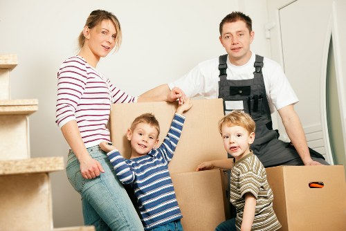 Removal team handling furniture and boxes in a Knightsbridge flat move
