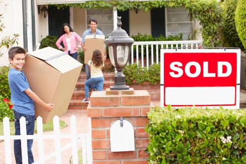 Trained removals staff carrying boxes with care