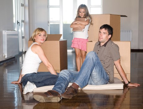 Removalists handling fragile furniture carefully during a local house move